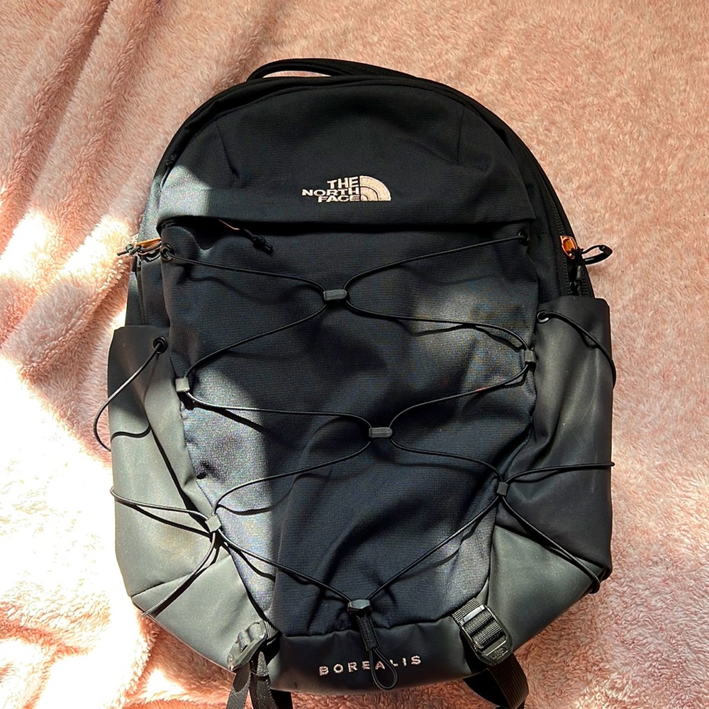 Black North Face book bag, has 4 pockets plus two side bottle pockets, big